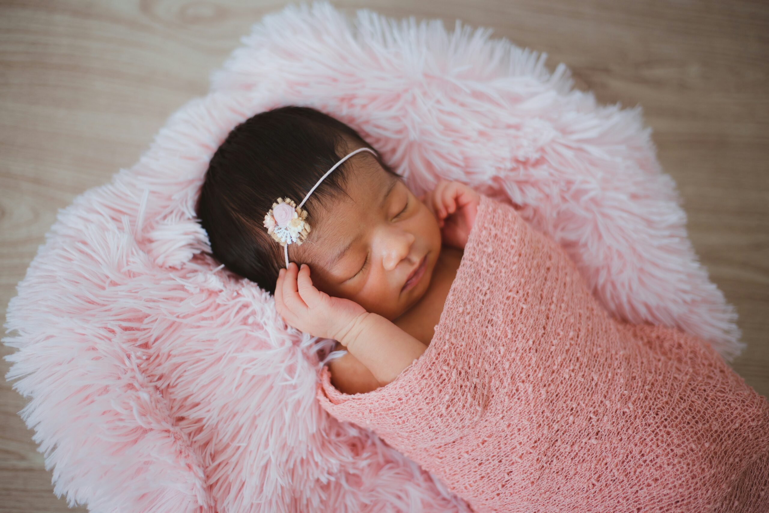 Baby on pink faux fur mat